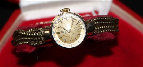 A ladys 9ct gold Omega manual wind wrist watch on an associated quadruple strand bracelet, with Omega box.